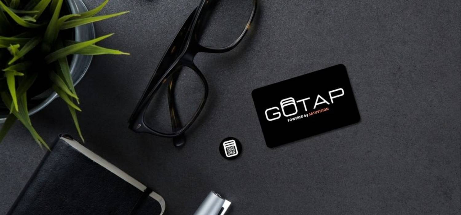 smart tag and smart business card between eye-glasses, notebook, pen, mini-plant on black desk