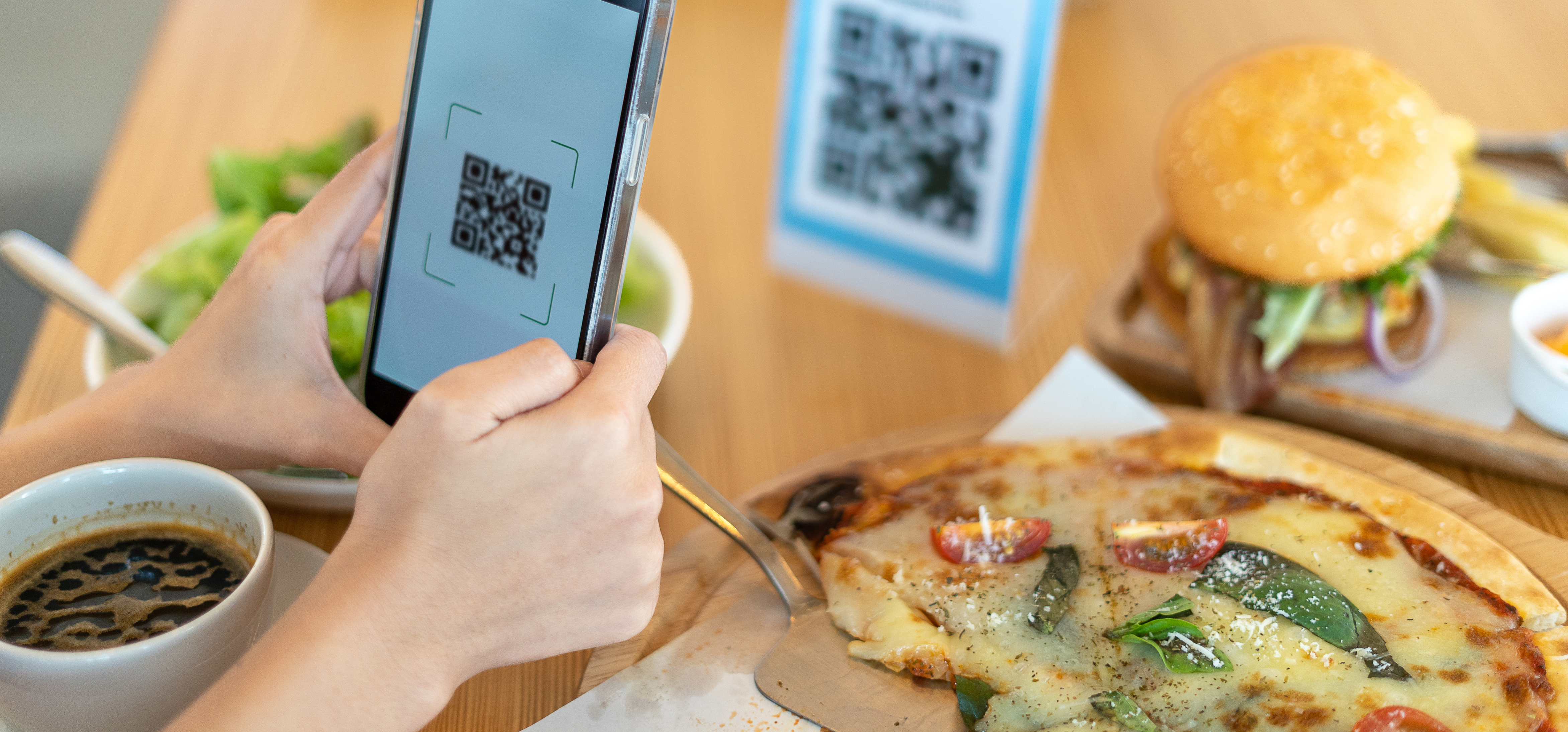 a woman is eating at an Italian pizza restaurant and the menu uses qr codes